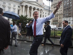 New York Mayor Bill de Blasio waves before a rally announcing a plan to fund MTA improvements on Monday, Aug. 7, 2017, in New York. De Blasio wants to tax the wealthiest 1 percent of city residents to fund repairs and improvements to the nation's largest subway system. (AP Photo/Michael Noble Jr.)