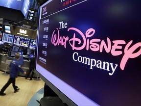 In this Monday, Aug. 7, 2017, photo, The Walt Disney Co. logo appears on a screen above the floor of the New York Stock Exchange. The Walt Disney Co. reports earnings, Tuesday, Aug. 8, 2017. (AP Photo/Richard Drew)