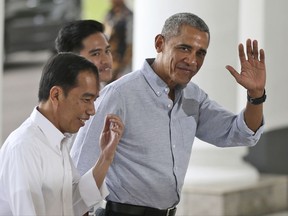 FILE - In this June 30, 2017, file photo, former U.S. President Barack Obama waves to reporters as he walks with Indonesian President Joko Widodo, left, upon arrival for their meeting at the Bogor Presidential Palace in Bogor, West Java, Indonesia. Obama's  Aug. 12, 2017, tweet in response to the violence in Charlottesville, Virginia, is already one of the platform's most-liked posts.(AP Photo/Dita Alangkara, Pool, File)