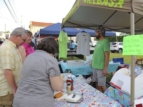 In a June 9, 2017 photo, John Vishefski from Tarnowski's Kielbasa waits on customers during the 2017 Edwardsville Pierogi Festival in Edwardsville, Pa. The Pennsylvania celebration of the popular Polish treat is embroiled in a food fight after the Whiting Pierogi Fest in Indiana threatened a trademark infringement lawsuit over the use of the name "Pierogi Festival."  (Frank C. Lauri/The Times & Tribune via AP)