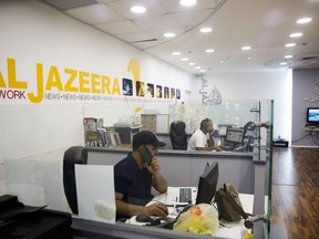 Employees sit in Al-Jazeera news network offices in Jerusalem, Tuesday August 8, 2017. Al-Jazeera, the Qatar-based news network that broadcasts internationally in English and Arabic, has once again been thrust into the center of the story, with the network's coverage back in the spotlight after Israel's moves to block it. (AP Photo/Mahmoud Illean)