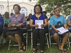 People gather at Plaza de Espana, to pray for peace in Hagatna, Guam Sunday, Aug. 13, 2017.  Residents of the U.S. Pacific island territory face a missile threat from North Korea.(AP Photo/Tassanee Vejpongsa)