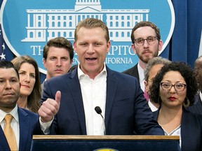 FILE -- In this Monday, July 17, 2017 file photo, Assembly Republican Leader Chad Mayes, R-Yucca Valley, center, discusses the cap-and-trade bill at the Capitol in Sacramento, Calif. Mayes who joined with six of his GOP colleagues in voting for the recent cap-and-trade bill, received $15,300 from the oil industry during the first half of 2017.(AP Photo/Rich Pedroncelli, file)
