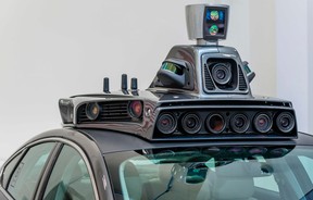 A pilot model of Uber’s self-driving car from 2016 shows the bulky apparatus. Magna says it can integrate that equipment into the body of the car.