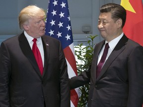 FILE - In this July 8, 2017, file photo, U.S. President Donald Trump, left, and Chinese President Xi Jinping arrive for a meeting on the sidelines of the G-20 Summit in Hamburg, Germany. The Wall Street Journal and New York Times reported Wednesday, Aug. 2, 2017, that the administration of President Trump is considering using rarely invoked U.S. trade laws to compel China to crack down on theft of copyrights, patents and other intellectual property and fend off technology sharing demands from Beijing. (Saul Loeb/Pool Photo via AP, File)