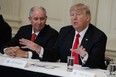 Blackstone CEO Stephen Schwarzman (left) and President Donald Trump attend a meeting with business leaders in the White House in February. The executive council, which is led by Schwarzman, planned to inform the White House Wednesday it was disbanding, sources say.