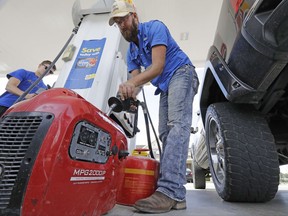 Aaron Berg fills up a gas can and his portable generator Thursday, Aug. 24, 2017, in Houston as Hurricane Harvey intensifies in the Gulf of Mexico. Harvey is forecast to be a major hurricane when it makes landfall along the middle Texas coastline. (AP Photo/David J. Phillip)