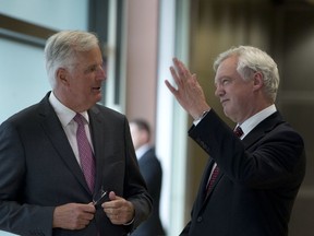 European Union chief Brexit negotiator Michel Barnier, left, speaks with British Secretary of State David Davis prior to a meeting at EU headquarters in Brussels on Monday, Aug. 28, 2017. The EU and Britain start a third round of Brexit negotiations on Monday. (AP Photo/Virginia Mayo)