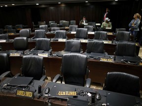 The seats of pro-government lawmakers sit empty during a session of Venezuela's National Assembly in Caracas, Wednesday, Aug. 2, 2017. The president of Venezuela's opposition-controlled National Assembly says the legislature will call for an investigation into claims that the official turnout figure in Sunday's election was tampered with. (AP Photo/Ariana Cubillos)