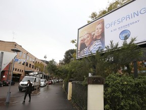 FILE - In this June 14, 2017 file photo, a billboard advertising a television show is displayed near the offices of the Ten Network in Sydney. Troubled Australian television broadcaster Ten Network will be sold to U.S. giant CBS Corp. subject to regulatory approval of foreign ownership, the Sydney-based company's administrator said on Monday, Aug. 28, 2017. (AP Photo/Rick Rycroft, File)