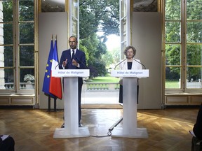 France's Prime Minister Edouard Philippe, left, and Labor Minister Muriel Penicaud give a media conference in Paris, Thursday, Aug. 31, 2017.  France's prime minister says five bold, and divisive, labor reforms are meant to "cure" not "treat the symptoms" of France's high long-standing jobless rate. (AP Photo/Thibault Camus)