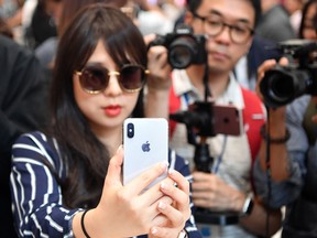 A woman tests out a new iPhone X during a media event at Apple's new headquarters in Cupertino, Calif.