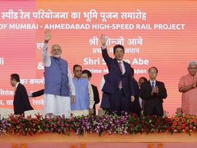 Japanese Prime Minister Shinzo Abe, right and Indian Prime Minister Narendra Modi wave during the ground breaking ceremony for high speed rail project in Ahmadabad, India, Thursday, Sept. 14, 2017. (AP Photo/Ajit Solanki)