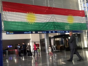 A Kurdish flag hangs in the Irbil International Airport, in Iraq, Wednesday, Sept. 27, 2017. Iraq's prime minister ordered the country's Kurdish region to hand over control of its airports to federal authorities or face a flight ban, a response to the Kurdish independence referendum. (AP Photo/Khalid Mohammed)