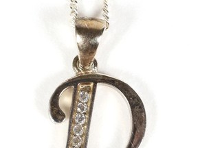 This August 2017 photo provided by RR Auction shows a silver necklace, featuring a charm in the shape of her first initial D, thought to have been worn as a teen by Princess Diana, that is among dozens of items with a direct connection to the princess that are being sold at auction by Boston-based RR Auction.  Bidding ends Sept. 13.  (Sarina Carlo/RR Auction via AP)