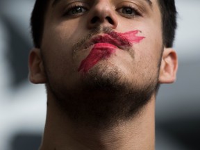 A student demonstrates against the position of the Spanish government to ban the Self-determination referendum of Catalonia during a university students strike Thursday in Barcelona, Spain.