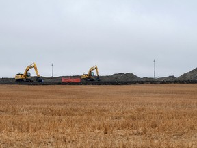 FILE - In this Oct. 11, 2013 file photo, cleanup continues on at the site of an oil pipeline leak and spill north of Tioga, N.D. Four years later, cleanup completion is in sight for the 20,000-barrel oil spill in a North Dakota farmer's field. Excavation of the affected site is scheduled for completion by the end of the month, with a test crop to be planted on the land next spring. The spill from a Tesoro pipeline was discovered by a Tioga farmer in September 2013. It has been called one of the largest onshore spills in U.S. history. (AP Photo/Kevin Cederstrom File)