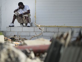 A sits on a porch on the destroyed Philipsburg after the passing of Hurricane Irma in St. Martin, Monday, September 11, 2017. Irma cut a path of devastation across the northern Caribbean, leaving thousands homeless after destroying buildings and uprooting trees. (AP Photo/Carlos Giusti)