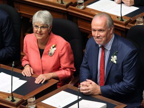 Premier John Horgan Deputy Premier Carole James look on before the speech from the throne in the legislative assembly in Victoria on September 8, 2017. British Columbia's finance minister has hinted that anyone looking for surprises in today's budget update will likely be disappointed. Carole James says the first financial blueprint put forward by the New Democrat government will outline commitments that were made on the election campaign last spring and reiterated in Friday's throne speech, which kicked off the latest legislative session. THE CANADIAN PRESS/Chad Hipolito