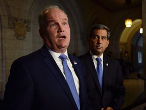 Conservative MP Erin O'Toole talks to media outside the House of Commons on Parliament Hill, as Tory MP Pierre Paul-Hus looks on, in Ottawa on June 20, 2017. Attack mode, says the Conservative Party's new foreign affairs critic, will not be the opposition's first instinct when dealing with the Liberal government's renegotiation of the North American Free Trade Agreement. Conservative MP Erin O'Toole says his party is willing to offer non-partisan support to the Liberal government during the continuing NAFTA renegotiation, which entered its second round this weekend in Mexico City. THE CANADIAN PRESS/Adrian Wyld