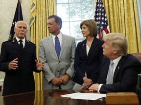 President Donald Trump addresses Commissioner David Hudson, National Commander, Salvation Army USA, left, Kevin Ezell, President of Southern Baptist Disaster Relief, American Red Cross CEO Gail McGovern, in the Oval Office of the White House, Friday, Sept. 1, 2017, in Washington. (AP Photo/Alex Brandon)