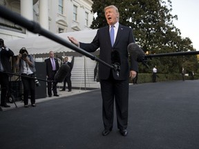 President Donald Trump talks to the media as he walks from Marine One to the White House in Washington, Wednesday, Sept. 27, 2017, as he returns from Indianapolis. (AP Photo/Carolyn Kaster)