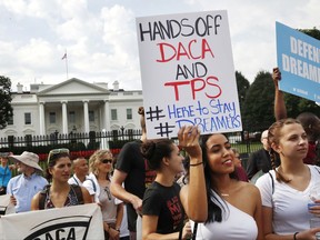 Yurexi Quinones, 24, of Manassas, Va., a college student who is studying social work and a recipient of Deferred Action for Childhood Arrivals, known as DACA, rallies next to Ana Rice, 18, of Manassas, Va., far right, in support of DACA, outside of the White House in Washington, Tuesday, Sept. 5, 2017. President Donald Trump plans to end a program that has protected hundreds of thousands of young immigrants brought into the country illegally as children and call for Congress to find a legislative solution. (AP Photo/Jacquelyn Martin)