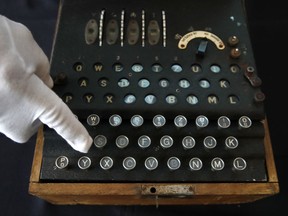 H. Keith Melton points to a key on an Enigma Machine with four rotors and a some Japanese characters that was used in World War II to encode messages, Wednesday, Sept. 13, 2017, in Washington. The machine is one of the many items that he is donating to the International Spy Museum from his collection of spy objects. (AP Photo/Jacquelyn Martin)