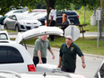 Ministry of the Environment and Climate Change Investigators, foreground, at Volkswagen headquarters in Ajax on Tuesday. Information to obtain the search warrant, which includes details of what the investigators were seeking, is sealed to the public until it has been fully executed.