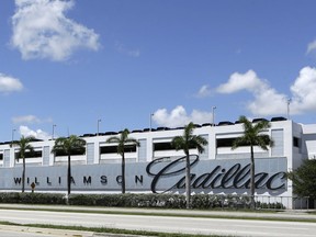 This photo taken Wednesday, Aug. 30, 2017, shows Williamson Cadillac Buick GMC dealership in Miami. If you're willing to fly, you can save when you buy. Perhaps thousands of dollars on a used SUV, car or truck. Used vehicle prices vary wildly between U.S. metro areas, sometimes over $3,000. So with some careful research and a plane ticket, it might be worth the time it takes to travel. (AP Photo/Alan Diaz)