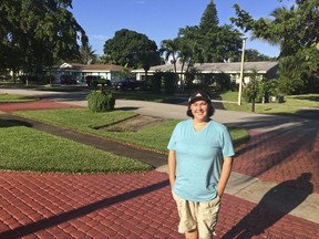 Business analyst Amanda Spartz poses for a photo Thursday, Aug. 31, 2017, in Plantation, Fla. Far fewer Americans are buying flood insurance in coastal areas of the United States where the threat is serious from hurricanes, storms and tidal surges, according to the latest government data.    Spartz decided to keep the flood insurance on her home after seeing the devastation Hurricane Harvey did to Houston.  (AP Photo/Terry Spencer)