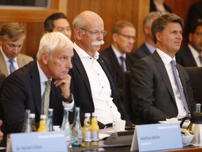FILE - In this Aug. 2, 2017 file photo Harald Krueger, CEO of German car maker BMW, Dieter Zetsche, chairman of German car maker Daimler AG and head of Mercedes-Benz cars and Matthias Mueller, CEO of German car maker Volkswagen, from right, attend a so-called diesel summit in Berlin. German government officials and automakers met to discuss the future of diesel vehicles. Diesel is one of the major themes at the Frankfurt International Motor Show, which opens for journalists Tuesday and Wednesday and to the general public from Saturday through Sept. 24, 2017. (Axel Schmidt/Pool Photo via AP, file)
