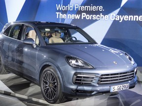 FILE - In this Aug. 29, 2017 file photo the new Porsche Cayenne is displayed during its world premiere in Stuttgart, southern Germany. Porsche is showing off the new Cayenne _ base model starting at 74,828 euros _ with two powerful six-cylinder gasoline engines at the 2017 Frankfurt Auto Show. (Sebastian Gollnow/dpa via AP)