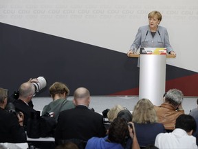 German Chancellor Angela Merkel speaks during a press conference after a board meeting of the Christian Democratic Union CDU in Berlin, Germany, Monday, Sept. 25, 2017, the day after the German parliament election. (AP Photo/Michael Sohn)