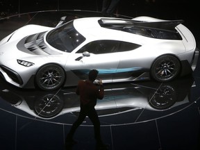 Formula One driver Lewis Hamilton films the Mercedes-AMG Project One hyper after the world premiere during an event of German carmaker Mercedes-Benz on the eve of the opening of the International Frankfurt Motor Show IAA in Frankfurt, Germany, Monday, Sept. 11, 2017, which runs through Sept. 24, 2017. (AP Photo/Michael Probst)