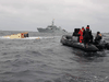 The HMCS Glace Bay in the distance with the hull of the capsized Miss Ally just visible.