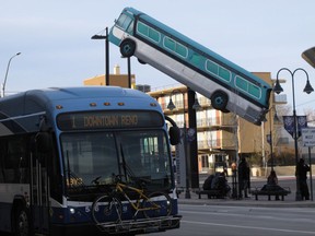 FILE - In this March 2, 2016 file photo, a city bus passes a sculpture in front of a bus station in downtown Reno, Nev. A federal judge has given northern Nevada's largest public transit system the green light to begin recording audio along with video surveillance on city buses despite objections from the bus drivers' union that it's an illegal invasion of privacy. U.S. District Judge Miranda Du said in a ruling this week neither the drivers nor their passengers have a right to privacy because conversations on public buses are not private. (AP Photo/Scott Sonner, File)