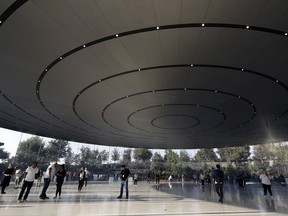 People arrive for a new product announcement at the Steve Jobs Theater on the new Apple campus, Tuesday, Sept. 12, 2017, in Cupertino, Calif. (AP Photo/Marcio Jose Sanchez)