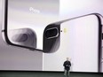 Phil Schiller, Apple's senior vice president of worldwide marketing, shows the new iPhone 8 at the Steve Jobs Theater on the new Apple campus on Tuesday, Sept. 12, 2017, in Cupertino, Calif.