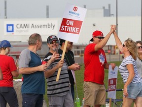 Employees of the GM CAMI assembly factory stand on the picket line in Ingersoll, Ont., on Monday, Sept. 18, 2017. The 2,500 members of Unifor local 88 walked out Sunday at 10:59 p.m. when negotiators for the union and the automaker failed to come to terms on a new contract agreement.