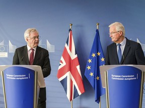 EU chief Brexit negotiator Michel Barnier, right, and British Secretary of State David Davis address the media prior to a meeting at the EU headquarters in Brussels,  Monday, Sept. 25, 2017. The European Union on Monday ramped up pressure on Britain ahead of a new round of Brexit talks, warning again that time is running out for Prime Minister Theresa May to clinch a deal. (AP Photo/Geert Vanden Wijngaert)