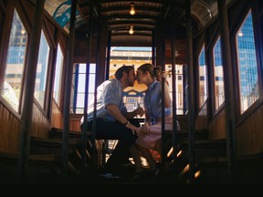 This undated photo provided by Lionsgate from the movie "La La Land" of Emma Stone and Ryan Gosling during a scene on the Angels Flight Railroad in downtown Los Angeles. The little funicular that carried the actors to the top of downtown Los Angeles in the movie has reopened to the general public Thursday, Aug. 31, 2017. (Lionsgate via AP)