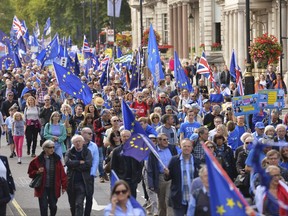 Demonstrators make their way along Piccadilly in London, Saturday Sept. 9, 2017, protesting Britain's plans to withdraw from the European Union. The marchers plan to converge on Parliament Square to challenge the government's plan to implement Brexit by 2019. (John Stillwell/PA via AP)