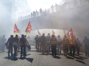 Workers demonstrate against government labor law, in Marseille, southern France, Tuesday, Sept. 12, 2017. President Emmanuel Macron's presidency is facing its first big public test, as unions hold nationwide protests against changes to labor laws that they fear corrode hard-fought job security. The prominent CGT union is leading Tuesday's protests, calling for strikes across transport and other public sector businesses and planning some 180 demonstrations. (AP Photo/Claude Paris)