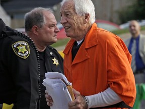 FILE - In this Aug. 12, 2016, file photo, former Penn State University assistant football coach Jerry Sandusky, right, arrives at the Centre County Courthouse in Bellefonte, Pa. Penn State University has filed paperwork indicating it intends to sue the charity founded by ex-assistant football coach Jerry Sandusky, whose child molestation scandal rocked the school in 2011. (AP Photo/Gene J. Puskar, File)