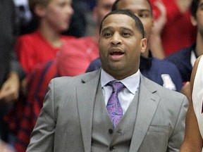 FILE - In this Dec. 11, 2013, file photo, Arizona's assistant coach Emanuel Richardson watches from the sideline during the second half of an NCAA college basketball game against New Mexico State in Tucson, Ariz. Richardson was identified in court papers, and is among 10 people facing federal charges in Manhattan federal court, Tuesday, Sept. 26, 2017, in a wide probe of fraud and corruption in the NCAA, authorities said (AP Photo/John Miller, File)