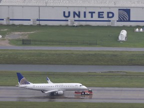 FILE - In this Tuesday, Aug. 29, 2017, file photo, a United Airlines plane is towed at George Bush Intercontinental Airport in Houston. United Airlines said Hurricane Harvey and a fare war contributed to a loss of $400 million in expected revenue, and the storm saddled the company with higher prices for jet fuel. The company said Wednesday, Sept. 6, that a key revenue-per-seat figure would fall by up to 5 percent for the third quarter. (AP Photo/David J. Phillip, File)
