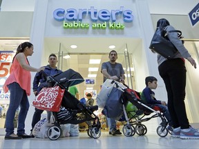 FILE - In this Tuesday, Feb. 9, 2016, file photo, people shop in Miami. After years of sluggish growth, typical U.S. household incomes finally topped pre-recession levels in 2016 and reached an all-time high, according to information released by the Census Bureau, Tuesday, Sept. 12, 2017. (AP Photo/Alan Diaz, File)