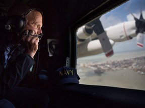 FILE - In this Monday, Sept. 11, 2017, file photo provided by the Governor's Press Office, Gov. Rick Scott looks out the window of a C-130 as he assesses damage to the Florida Keys during the aftermath of Hurricane Irma. Hurricane Irma delivered a serious punch to Florida agriculture but producers and officials have only barely begun to assess the damage to the state's citrus, sugar cane and vegetable crops. (Jesse Romimora/Governor's Press Office via AP, File)