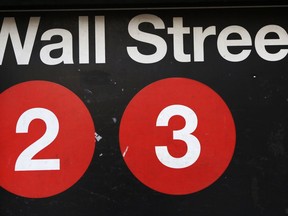 FILE - This Friday, Jan. 15, 2016, file photo shows a sign for a Wall Street subway station in New York. U.S. stocks are jumping along with bond yields and interest rates early Wednesday, Sept. 27, 2017, and technology companies continue to recover some of their recent losses. Athletic gear giant Nike is falling as investors are concerned about the health of its U.S. business. (AP Photo/Mark Lennihan, File)